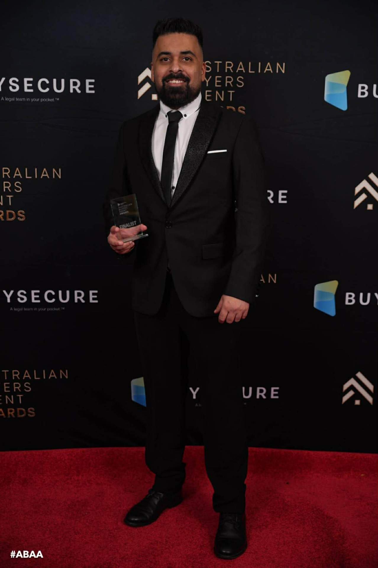 Manny Singh, founder of BuyersKey, holding the Australian Buyers Agent Awards 2026 Finalist trophy
